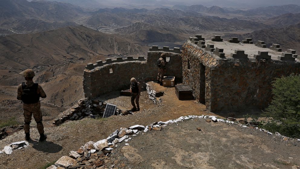 FILE - In this Aug. 3, 2021 file photo, Pakistan Army troops observe the area from hilltop post on the Pakistan Afghanistan, in Khyber district, Pakistan. Pakistani authorities Monday, Nov. 8, 2021 announced a month-long cease-fire with a key militan