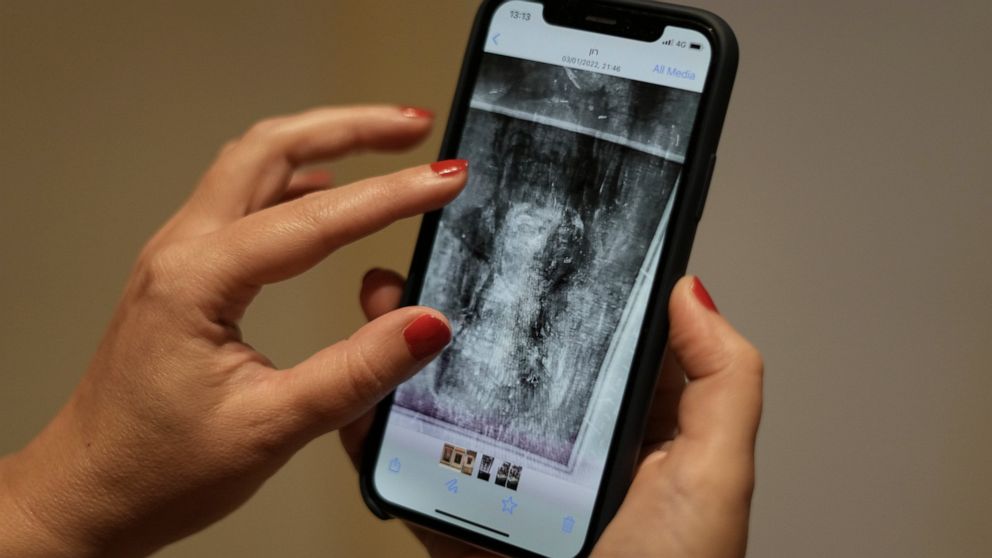 Inna Berkowits, an art historian at the Haifa University's Hecht Museum, holds her mobile phone with an image of an x-ray of Amedeo Modigliani's painting "Nude with a Hat" in Haifa, Israel, June 28, 2022. Curators at the museum using x-ray technology