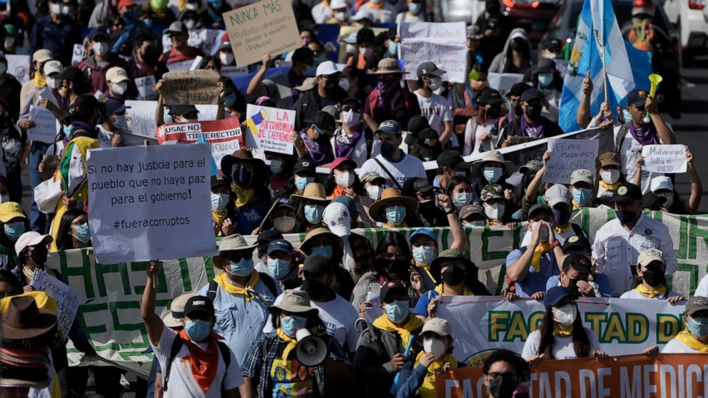 People march to protest against government of President Alejandro Giammattei in Guatemala City, Thursday, Aug. 11, 2022. Student and peasant sectors called for the march to protest everything from government corruption to the high cost of living. The