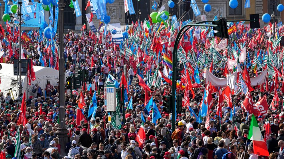 Demonstrators take part in a march organized by Italy's main labor unions, in Rome's St. John Lateran square, Saturday, Oct. 16, 2021. The march was called a week after protesters, armed with sticks and metal bars, smashed their way into the headquar