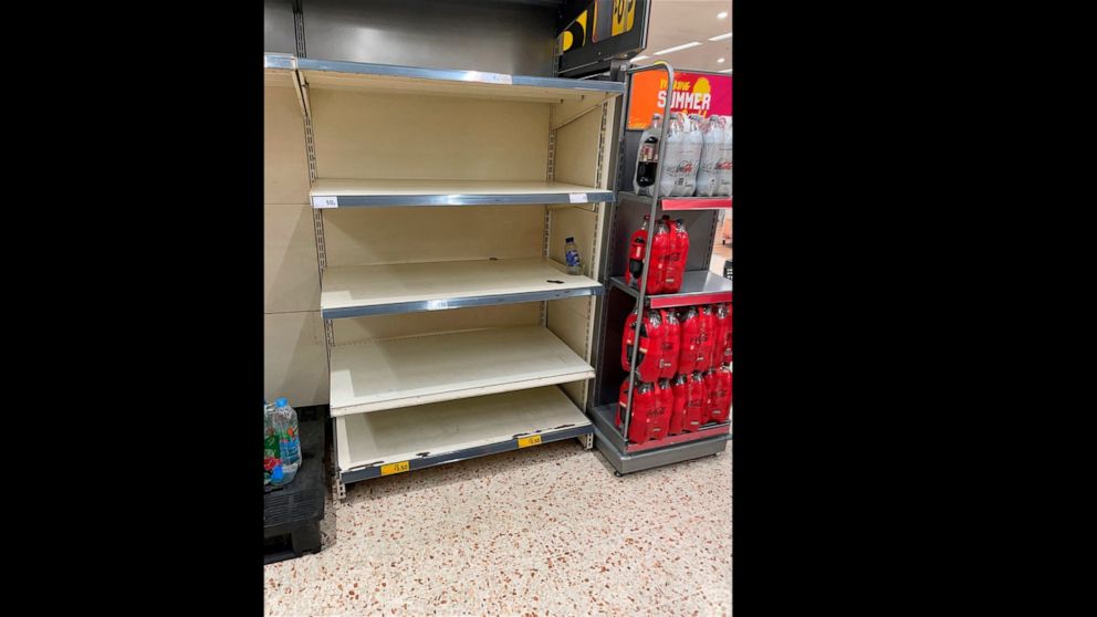 A view of empty shelves at a Morrisons storem in BelleVale, Liverpool, England, Wednesday July 21, 2021. Retailers in England warned Thursday of barren supermarket shelves as more and more staff get “pinged” on their phones to self-isolate because of