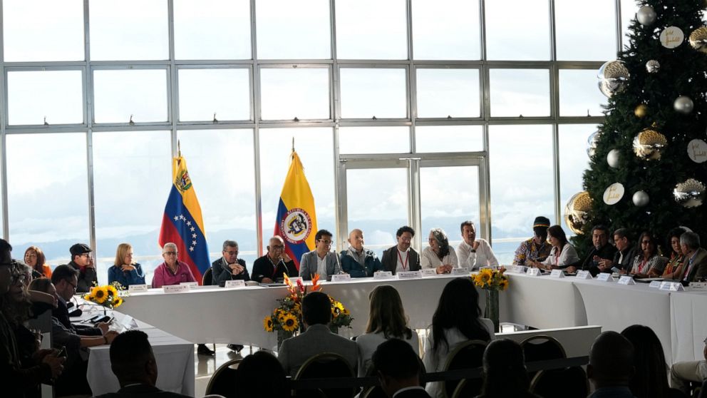 Delegations representing the Colombian guerrilla National Liberation Army (ELN), left side of table, and the Colombian government sit together to restart peace talks after a suspension of more that three years, at the hotel Humboldt in Caracas, Venez