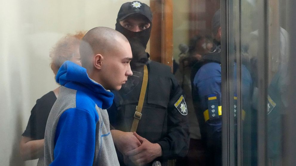 Russian army Sergeant Vadim Shishimarin, 21, is seen behind a glass during a court hearing in Kyiv, Ukraine, Friday, May 13, 2022. The trial of a Russian soldier accused of killing a Ukrainian civilian opened Friday, the first war crimes trial since 