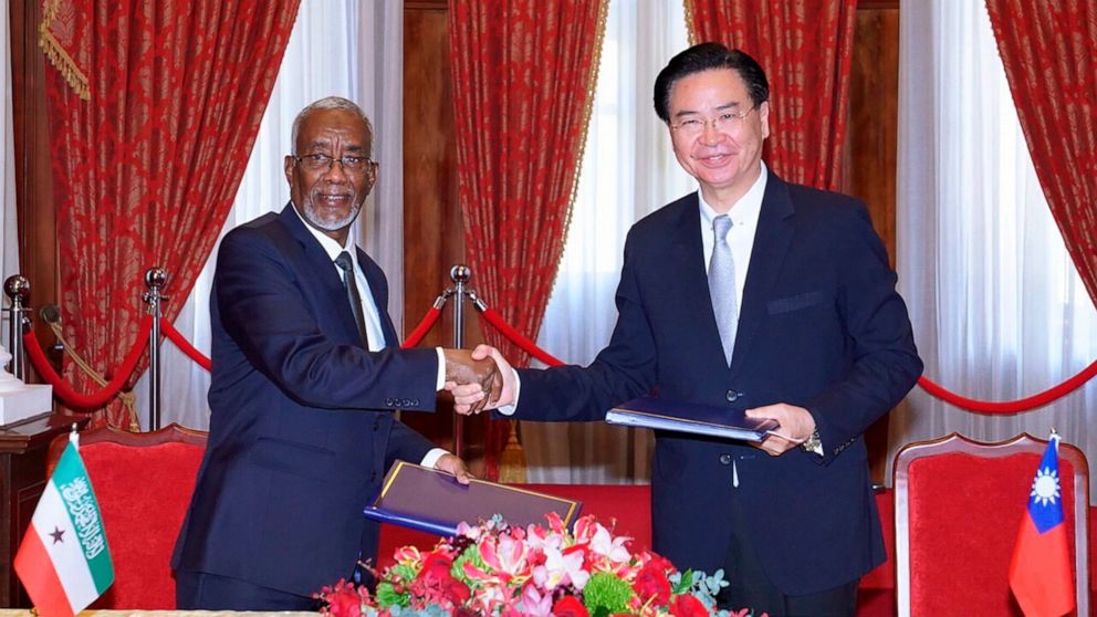 In this photo released by the Taiwan Ministry of Foreign Affairs, Taiwan's Foreign Minister Joseph Wu, right, and his counterpart from Somaliland, Yasin Hagi Mohamoud shake hands after signing an agreement for setting up representative offices in the