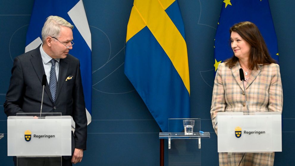 FILE - Finland's Minister for Foreign Affairs Pekka Haavisto, left and his Swedish counterpart Ann Linde take part in a joint press conference with Sweden's Defence Minister Peter Hultqvist, and his Finnish counterpart Antti Kaikkonen, in Stockholm, 