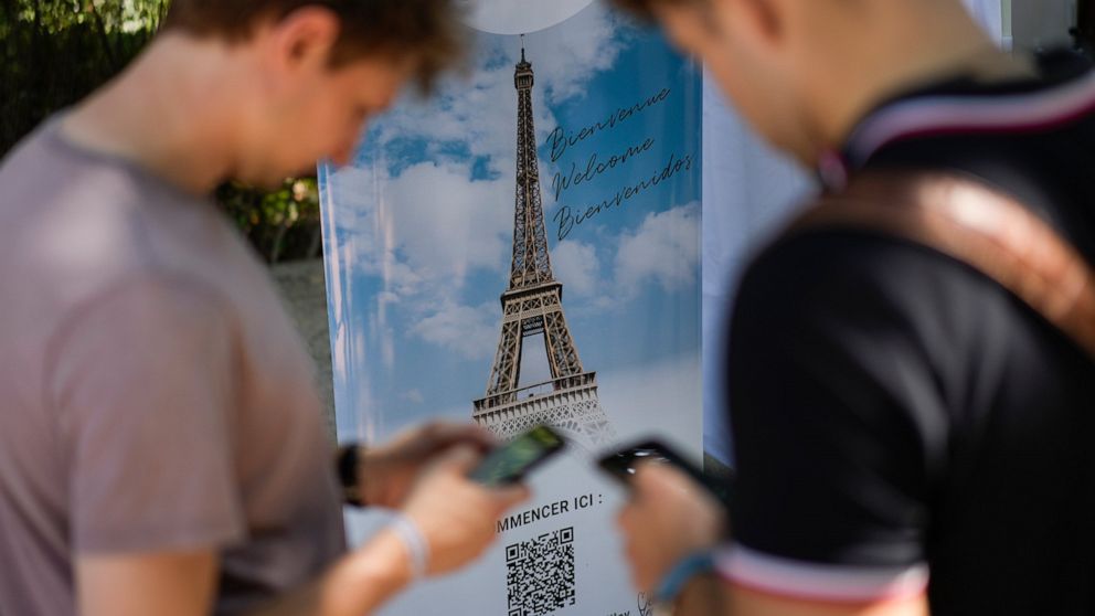 Visitors register for covid-19 tests at the Eiffel Tower in Paris, Wednesday, July 21, 2021. Visitors now need a special COVID pass to ride up the Eiffel Tower or visit French museums or movie theaters, the first step in a new campaign against what t