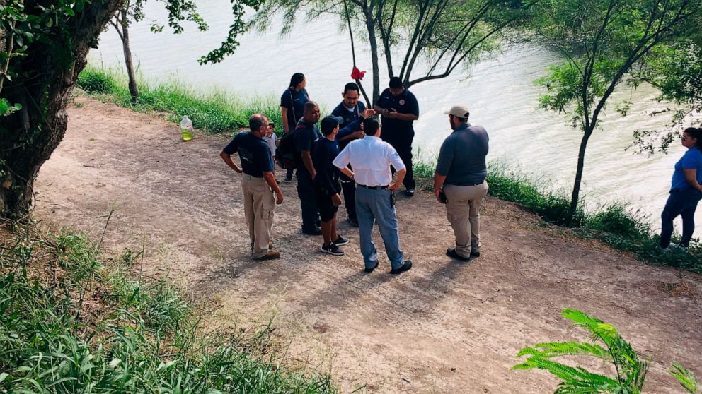 Mexican authorities stand along the Rio Grande bank where the bodies of Salvadoran migrant Oscar Alberto Martínez Ramírez and his nearly 2-year-old daughter Valeria were found, in Matamoros, Mexico, Monday, June 24, 2019, after they drowned trying to