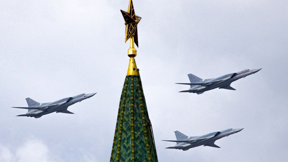 FILE - In this Thursday, May 5, 2016 file photo, Russian Tu-22M3 bombers fly over the Kremlin's Tower with a Red Star on the top during a general rehearsal for the Victory Day military parade which will take place at Moscow's Red Square on May 9 to c