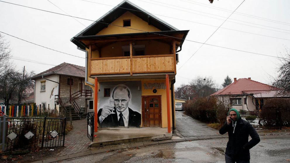 FILE - A man walks past a mural depicting Vladimir Putin, in Zvecan, Kosovo, Dec. 15, 2018. For some European countries watching Russia's bloody invasion of Ukraine, there are fears that they could be next. Western officials say the most vulnerable c