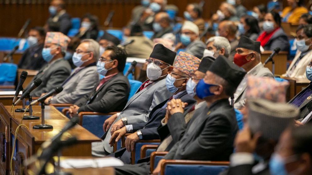 Members of parliament sit as they begin session in Kathmandu, Nepal, Sunday, March 7, 2021. Nepal’s Parliament reinstated by the nation's Supreme Court began session on Sunday that would likely determine the future of the prime minister and governmen