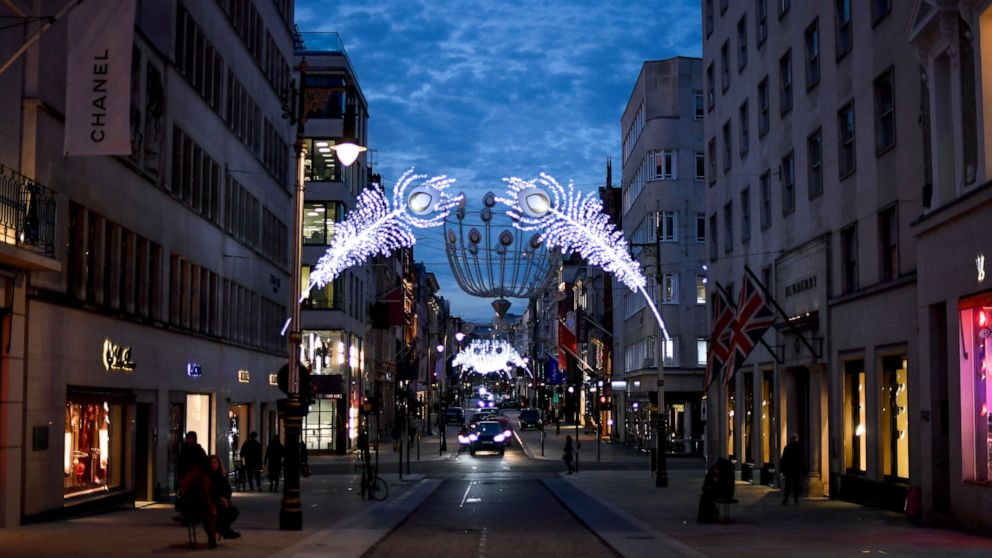 Christmas lights are lit up on New Bond Street in Mayfair, London, Tuesday, Nov. 24, 2020. Haircuts, shopping trips and visits to the pub will be back on the agenda for millions of people when a four-week lockdown in England comes to an end next week