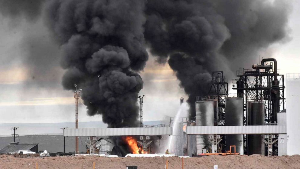 Smoke rises from the New American Oil (NAO) refinery in Plaza Huincul, Neuquen province, Argentina,Thursday, Sept. 22, 2022. An explosion caused a major fire this morning at the NAO refinery, killing several people the town’s mayor said. (Fernando Ra