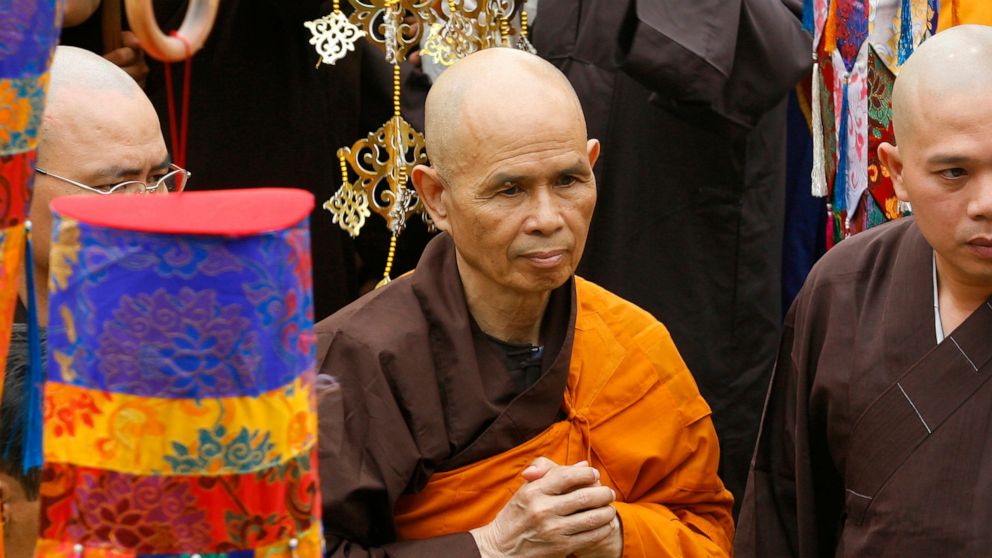 FILE - Vietnamese Zen master Thich Nhat Hanh, center, arrives for a great chanting ceremony at Vinh Nghiem Pagoda in Ho Chi Minh City, Vietnam on March 16, 2007. Zen Buddhist monk Thich Nhat Hanh, who helped pioneer the concept of mindfulness in the 