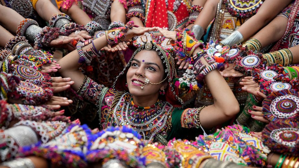 Women wearing traditional attire pose for photographs as they practice the Garba, the traditional dance of Gujarat state, ahead of Navratri in Ahmedabad, India, Tuesday, Sept. 20, 2022. The Hindu festival of Navratri, or nine nights, will begin Sept.