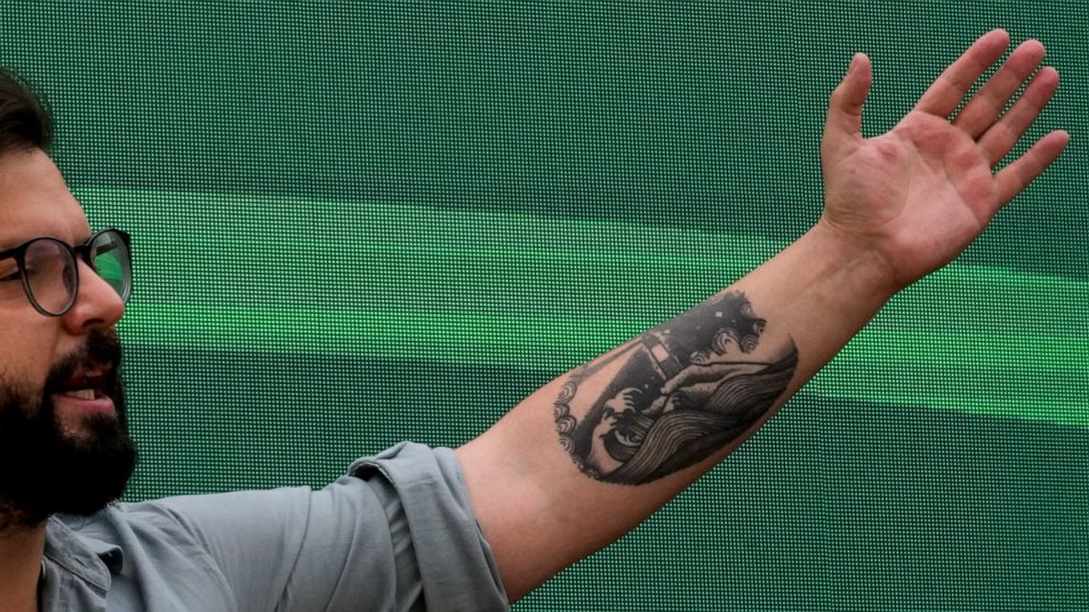 A tattoo of a lighthouse set on the Strait of Magellan decorates the arm of then presidential candidate Gabriel Boric during a rally in Santiago, Chile, Monday, Nov. 1, 2021. The tattoo on the now President-elect´s arm is by Chilean tattoo artist Yum