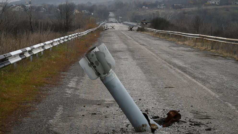A tail of a multiple rocket sticks out of the ground near the recently recaptured village of Zakitne, Ukraine, Wednesday, Nov. 9, 2022. This was the year war returned to Europe, and few facets of life were left untouched. Russia’s invasion of its nei