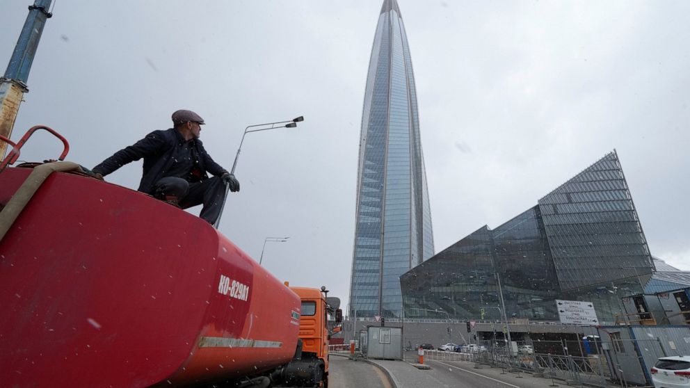 FILE - A worker sits on his water tank truck next to the business tower Lakhta Centre, the headquarters of Russian gas monopoly Gazprom in St. Petersburg, Russia, Wednesday, April 27, 2022. European gas prices have risen Friday, May 13, 2022 after Ru