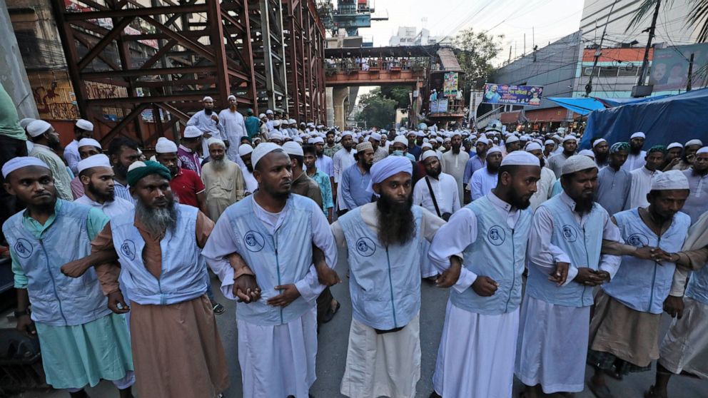 Muslims lock hands during a protest over an alleged insult to Islam, outside the country’s main Baitul Mukarram Mosque in Dhaka, Bangladesh, Saturday, Oct. 16, 2021. Thousands of Muslims protested in Bangladesh’s capital on Saturday for what they per