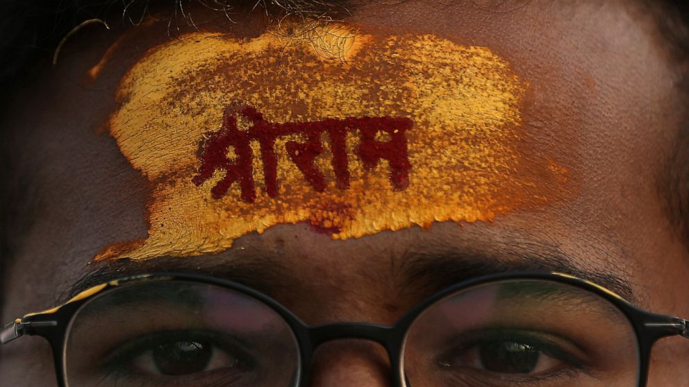 A devotee has the name of Hindu god Rama written on his forehead during a religious procession to celebrate Ram Navami, a Hindu festival marking the birth anniversary of Lord Ram, in Hyderabad, India, Sunday, April 10, 2022. India’s hardline Hindu na