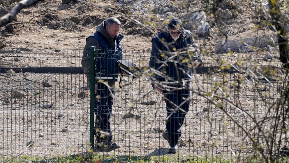 Police inspect site of a drone crash in Zagreb, Croatia, Friday, March 11, 2022. A drone that apparently flew all the way from the Ukrainian war zone crashed overnight on the outskirts of the Croatian capital, Zagreb, triggering a loud blast but caus