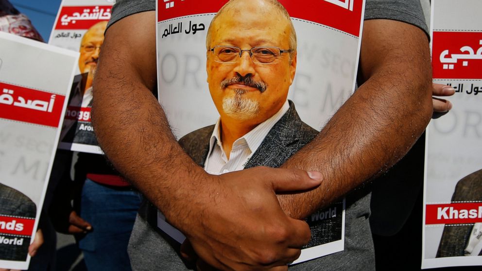 FILE - People hold posters of slain Saudi journalist Jamal Khashoggi, near the Saudi Arabia consulate in Istanbul, Oct. 2, 2020, marking the two-year anniversary of his death. In a surprise development, the prosecutor in the case against 26 Saudi nat
