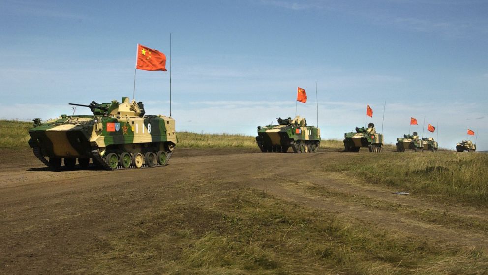 FILE - In this Aug. 13, 2007, file photo, a convoy of Chinese APCs roll by during a rehearsal for a massive joint military exercise by the two former Cold War rivals, the first on Russia's territory in the Chelyabinsk region in Russia's Ural Mountain