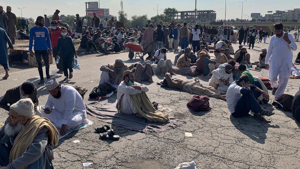 Supporters of 'Tehreek-e-Labaik Pakistan, a religious political party, take a rest while blocking a main road during an anti-France rally in Islamabad, Pakistan, Monday, Nov. 16, 2020. The supporters are protesting the French President Emmanuel Macro