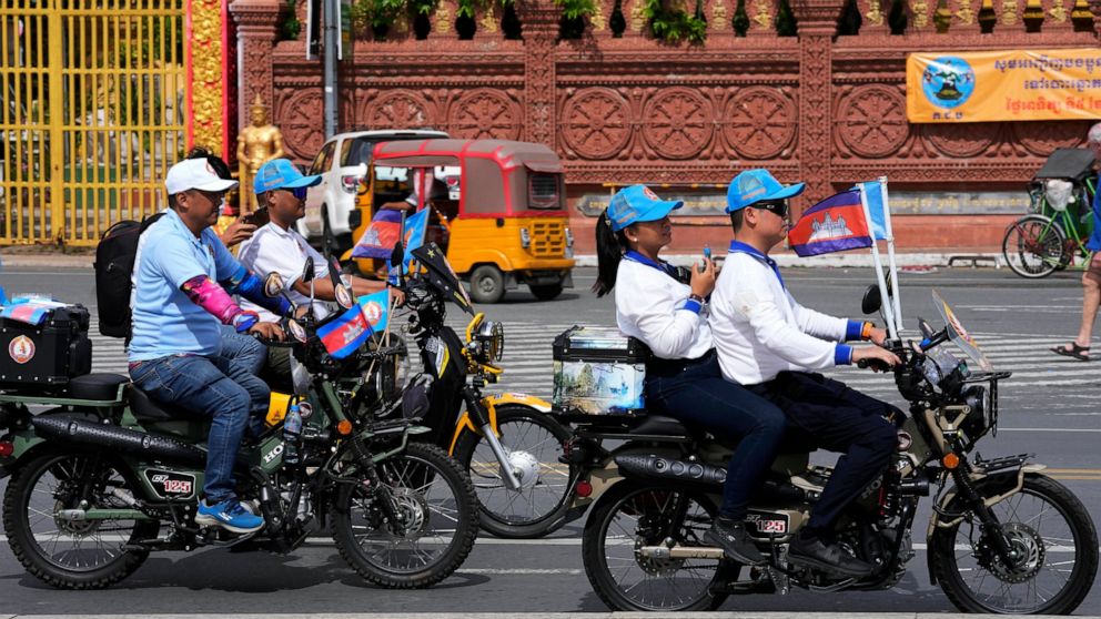 Cambodian People's Party (CPP) supporters drive motorbikes during the last day of campaigning ahead of the June 5 communal elections, in Phnom Penh, Cambodia, Friday, June 3, 2022. (AP Photo/Heng Sinith)