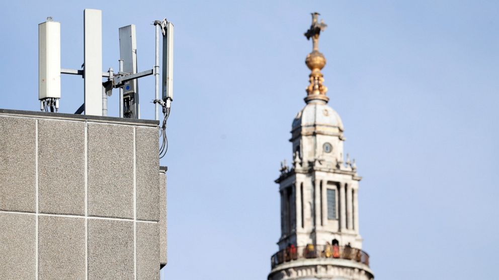Mobile network phone masts are visible in front of St Paul's Cathedral in the City of London, Tuesday, Jan. 28, 2020. The Chinese tech firm Huawei has been designated a "high-risk vendor" but will be given the opportunity to build non-core elements o