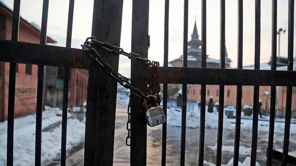 In this Nov. 8, 2019 photo, a lock is seen on the entrance gate of grand Jamia Masjid, the main mosque in Srinagar, Indian controlled Kashmir. The centuries-old Jamia Masjid in Srinagar city, apart from hosting the largest Muslim gatherings in disput