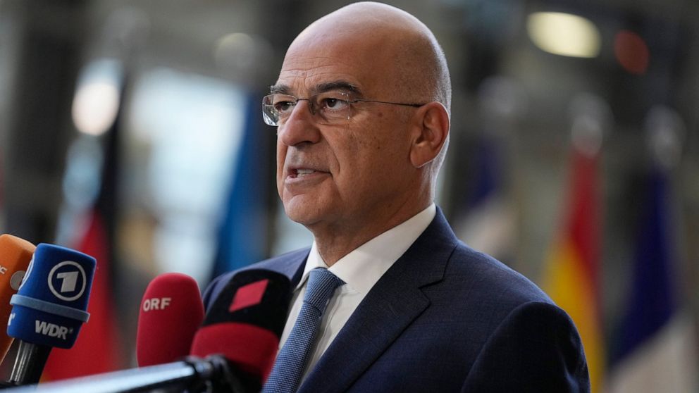 Greece's Foreign Minister Nikos Dendias speaks with the media as he arrives for a meeting of EU foreign ministers at the European Council building in Brussels, Monday, December 12, 2022. (AP Photo/Virginia Mayo)