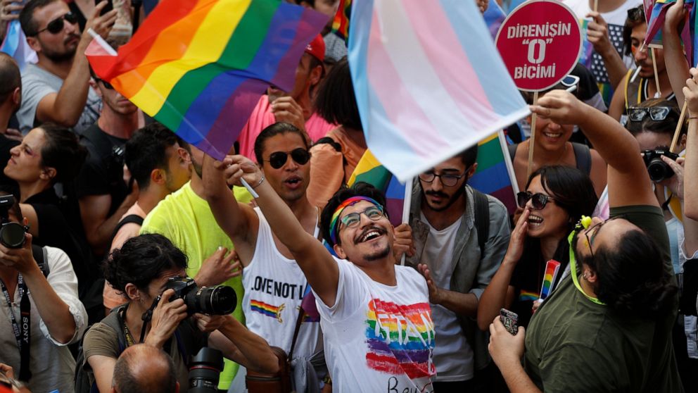 People celebrate on the street in central Istanbul, during a pride event in Istanbul, Sunday, June 30, 2019. Activists gathered in Istanbul to promote rights for gay and transgender people Sunday before police dispersed the crowd at a pride event tha