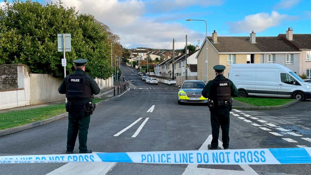 Officers from the Police Service of Northern Ireland (PSNI) stand guard at the scene, following the attempted murder of two officers in Strabane, Northern Ireland, Friday Nov. 18, 2022. (David Young/PA via AP)