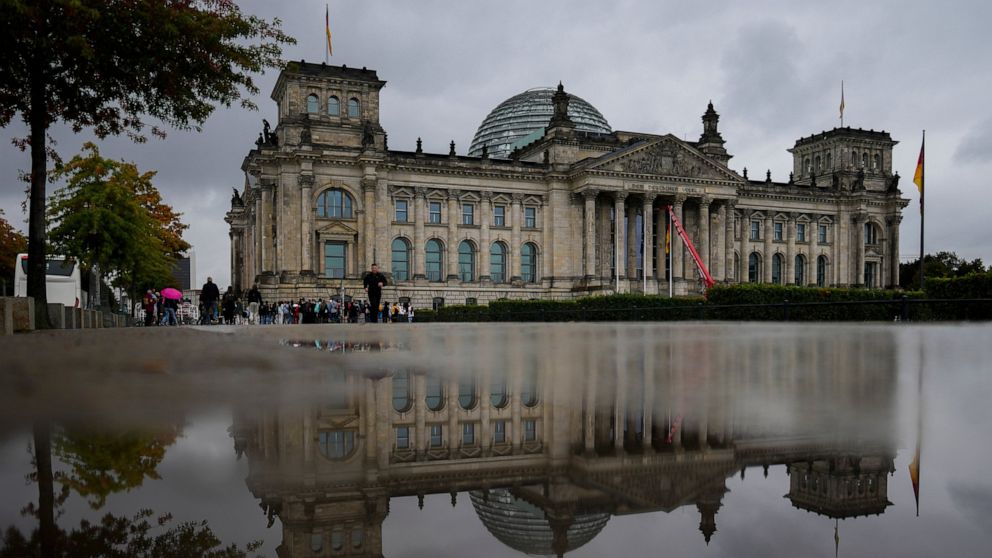 The Reichstag Building which are the German parliament Bundestag building reflected in a puddle in Berlin, Tuesday, Sept. 28, 2021. Sunday's national election making Germany's lower house of parliament, or Bundestag, more diverse and inclusive than e