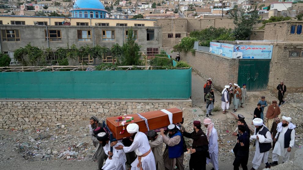 Mourners carry the body of a victim of a mosque bombing in Kabul, Afghanistan, Thursday, Aug. 18. 2022. A bombing at a mosque in Kabul during evening prayers on Wednesday killed at least 10 people, including a prominent cleric, and wounded over two d