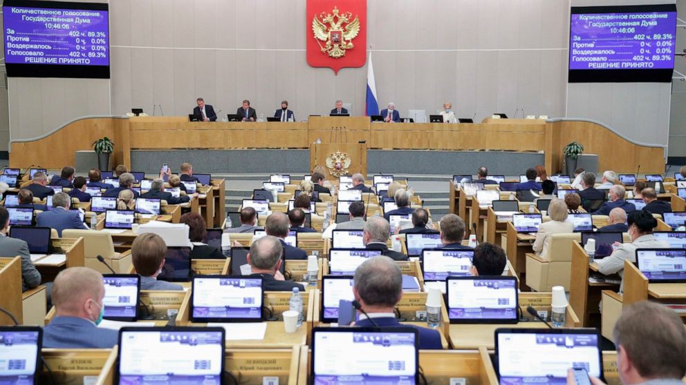 In this photo provided by the State Duma, deputies attend a session at the State Duma, the Lower House of the Russian Parliament in Moscow, Russia, Wednesday, May 19, 2021. The Russian parliament's lower house has voted to withdraw from an internatio