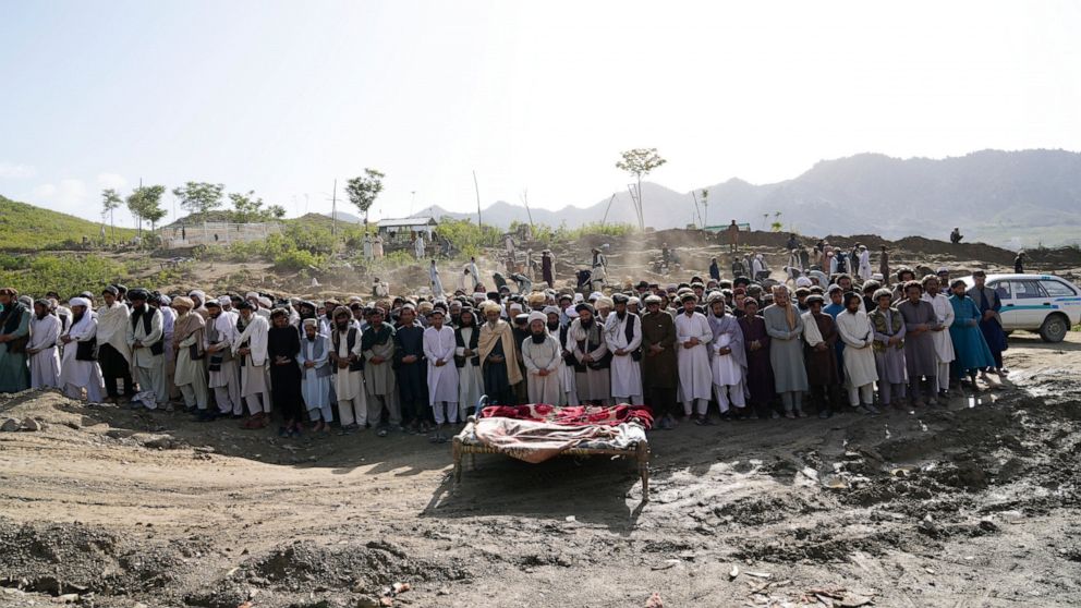 Afghans pray for relatives killed in an earthquake to a burial site l in Gayan village, in Paktika province, Afghanistan, Thursday, June 23, 2022. A powerful earthquake struck a rugged, mountainous region of eastern Afghanistan early Wednesday, flatt