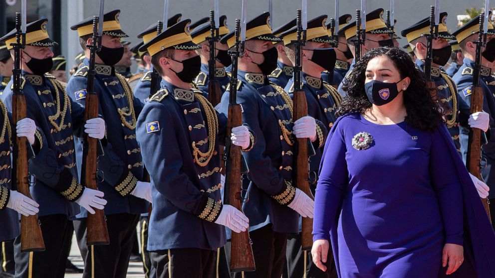 Kosovo newly elected president Vjosa Osmani-Sadriu, inspects the Guard of Honour during a presidential hand over ceremony in capital Pristina, Kosovo, on Tuesday, April 6, 2021. 38-year old Osmani took over the presidency after being elected to the p