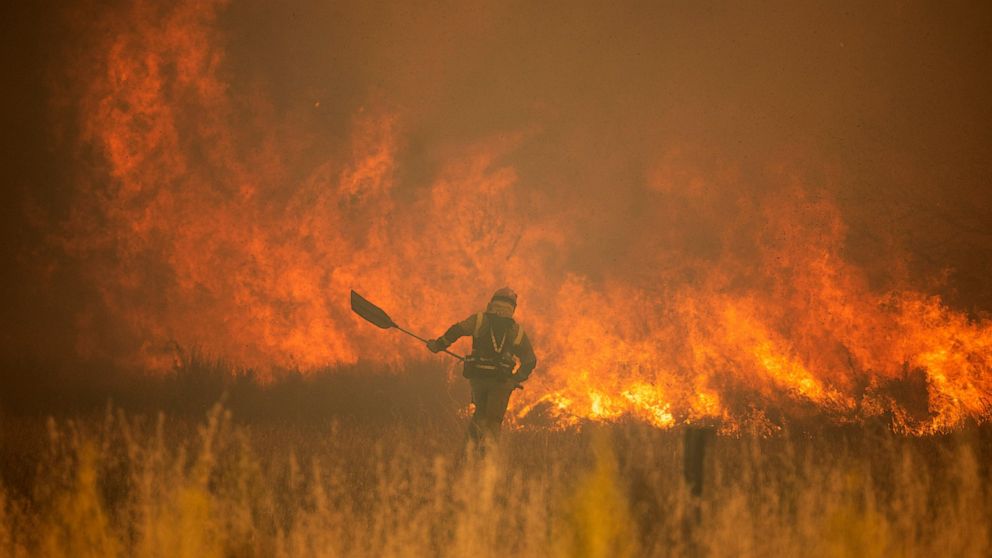 A firefighter works in front of flames during a wildfire in the Sierra de la Culebra in the Zamora Provence on Saturday June 18, 2022. Thousands of hectares of wooded hill land in northwestern Spain have been burnt by a wildfire that forced the evacu