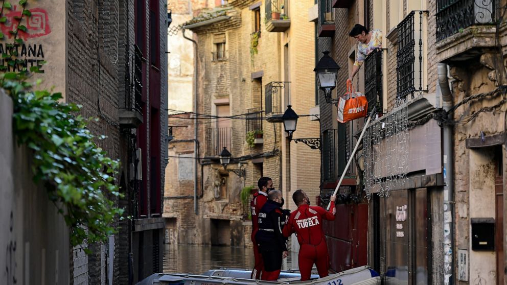 At least 1 dead as swollen rivers flood streets in Spain