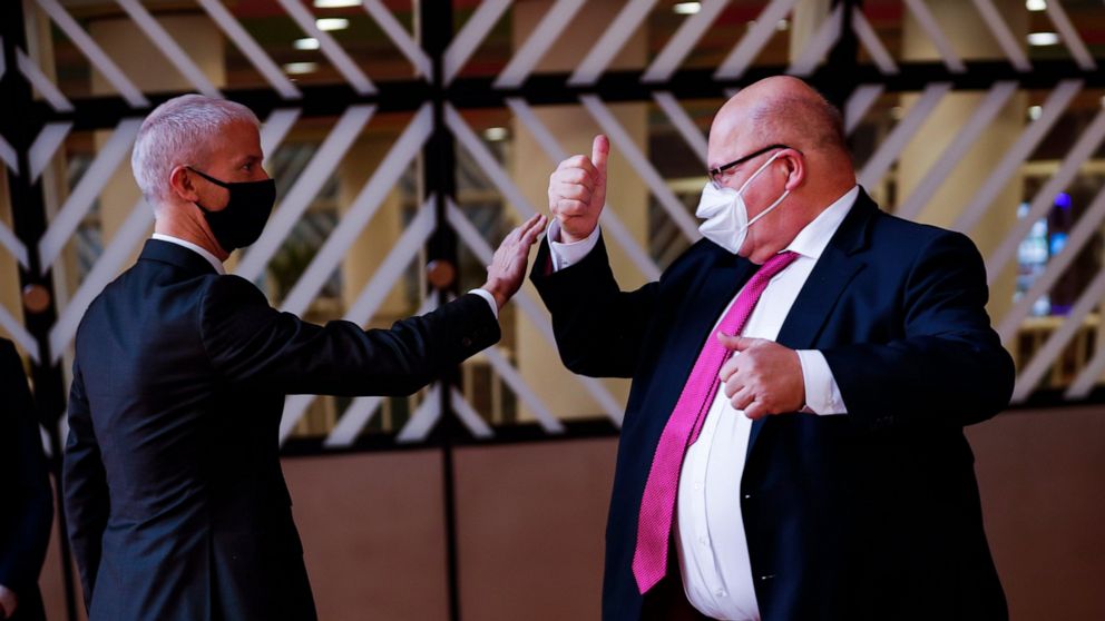 Germany's Economy and Energy Minister Peter Altmaier, right, greets France's Foreign Trade Minister Franck Riester prior to a European Foreign Trade ministers meeting at the European Council headquarters in Brussels, Thursday, May 20, 2021. (AP Photo