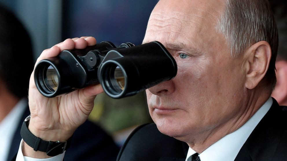 FILE - Russian President Vladimir Putin holds binoculars while watching the military exercises Center-2019 at Donguz shooting range near Orenburg, Russia, in Sept. 20, 2019. Russian President Vladimir Putin has warned that he wouldn't hesitate to use
