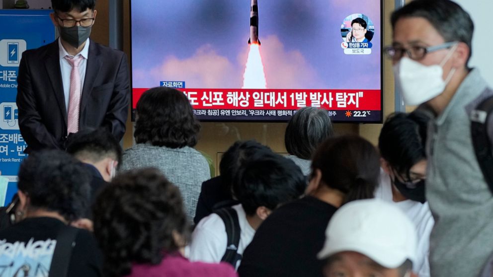 People watch a TV showing a file image of North Korea's missile launch during a news program at the Seoul Railway Station in Seoul, South Korea, Saturday, May 7, 2022. North Korea fired a suspected ballistic missile designed to be launched from a sub