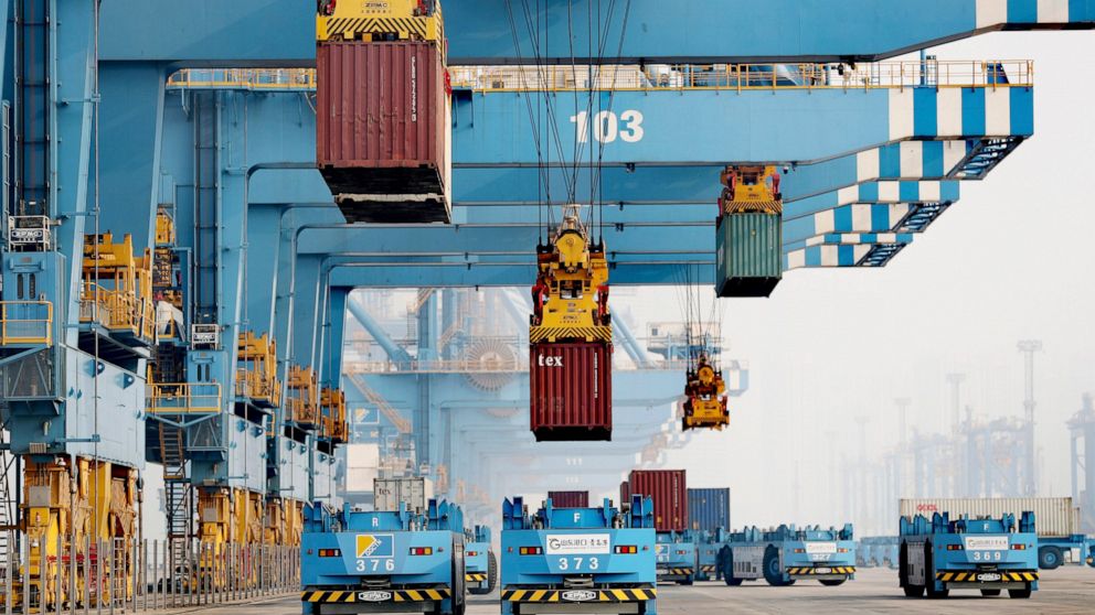Driverless vehicles move shipping containers at a port in Qingdao in eastern China's Shandong Province, Thursday, Jan. 6, 2022. China's politically volatile global trade surplus surged to $676.4 billion in 2021, likely the highest ever recorded by an