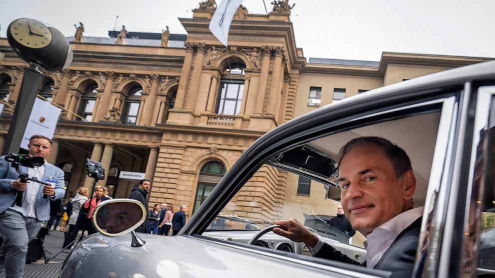 CEO of Porsche car maker Oliver Blume sits in an old Porsche 356 at the start of Porsche's market listing at the stock market in Frankfurt, Germany, Thursday, Sept. 29, 2022. (AP Photo/Michael Probst)