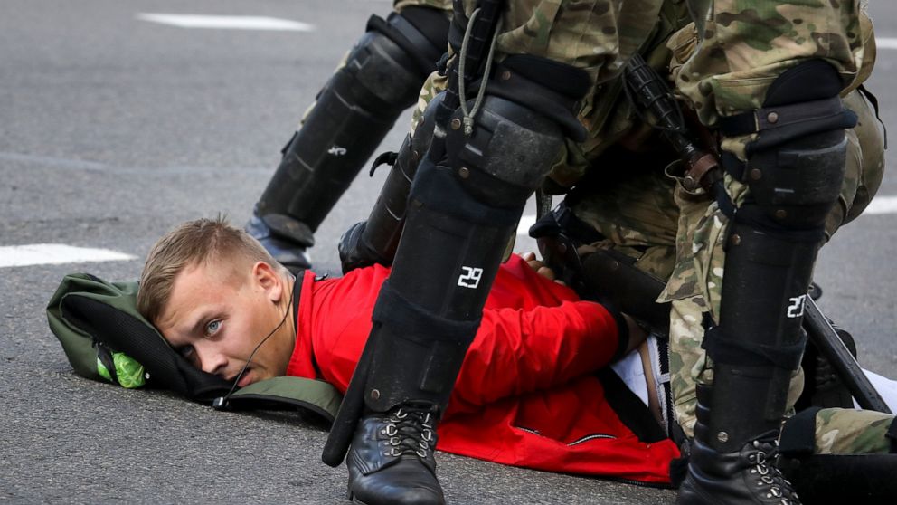 Riot police officers detain a protester during a Belarusian opposition supporters' rally protesting the official presidential election results in Minsk, Belarus, Sunday, Sept. 13, 2020. Protests calling for the Belarusian president's resignation have
