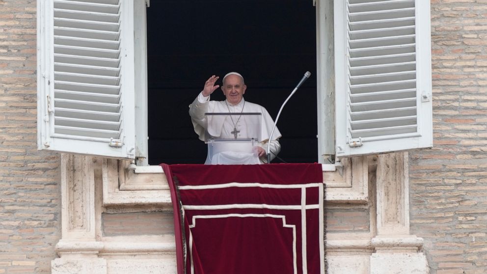 Pope Francis salutes from the window of his studio overlooking St. Peter's square at the Vatican, as he recites the Angelus prayer Tuesday, June 29, 2021. (AP Photo/Gregorio Borgia)