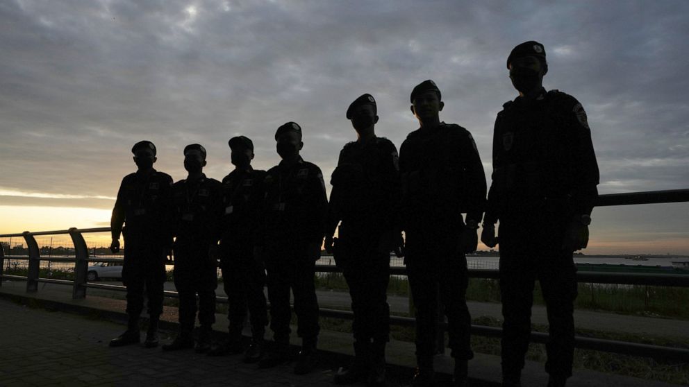Security personnel are silhouetted as they stand guard near a hotel where the 55th ASEAN Foreign Ministers' Meeting (55th AMM) is taking place in Phnom Penh, Cambodia, Tuesday, Aug. 2, 2022. Southeast Asian foreign ministers are gathering in the Camb