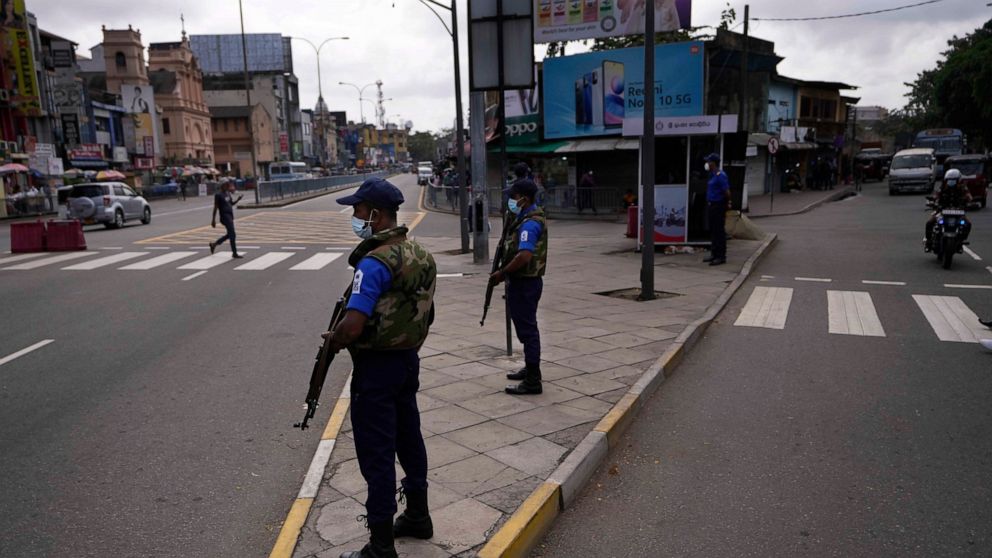 Sri Lankan navy soldiers stand guard at an intersection during a relaxation in a nationwide curfew that began Monday evening in Colombo, Sri Lanka, Thursday, May 12, 2022. Sri Lanka's president on Wednesday promised to appoint a new prime minister, e