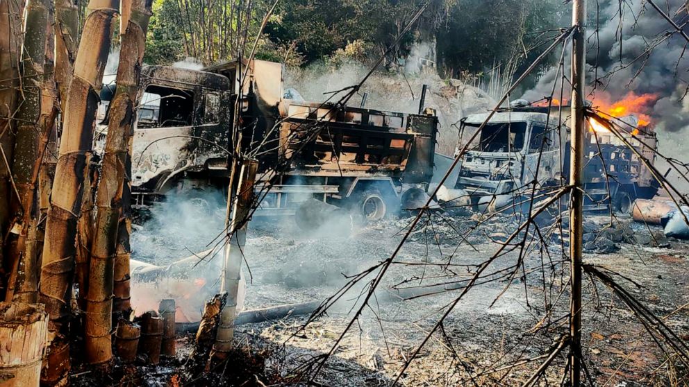 In this photo provided by the Karenni Nationalities Defense Force (KNDF), smokes and flames billow from vehicles in Hpruso township, Kayah state, Myanmar, Friday, Dec. 24, 2021. Myanmar government troops rounded up villagers, some believed to be wome